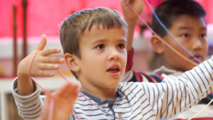 two elementary boys working with yarn at Waldorf School of the Peninsula