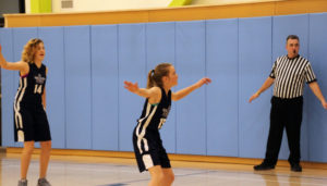 middle school girls basketball team playing on the court