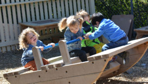 school kids playing on playground equipment