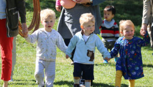 children holding hands outside