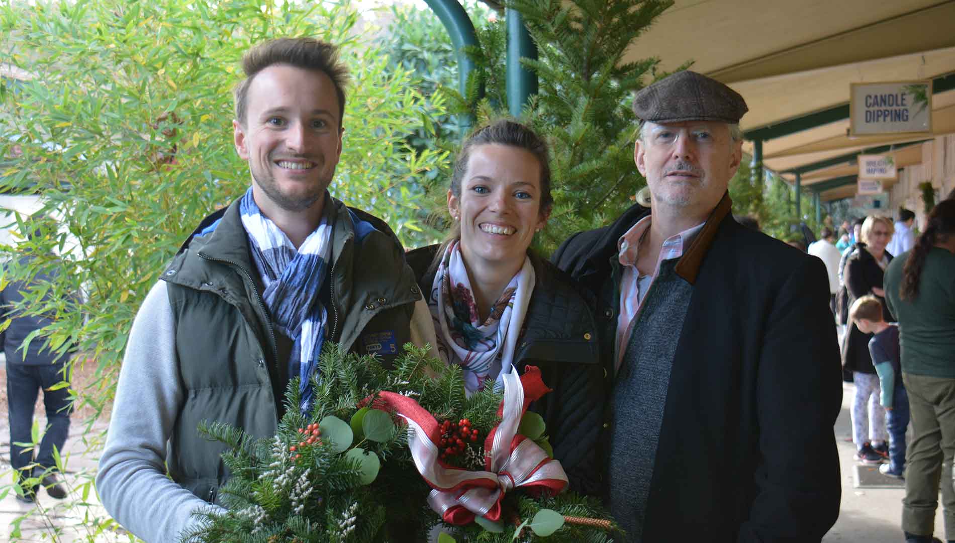 group of people smiling with their wreaths at Holiday Faire