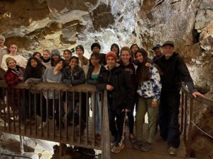 Eighth grade students and teachers inside of a cave