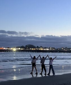 Three students enjoying the beach in Santa Cruz